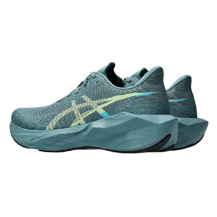 Снимка под ъгъл на маратонки Asics Novablast 6 в морско синьо, видяни отстрани.